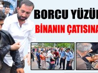 BORCU YÜZÜNDEN BİNANIN ÇATISINA ÇIKTI